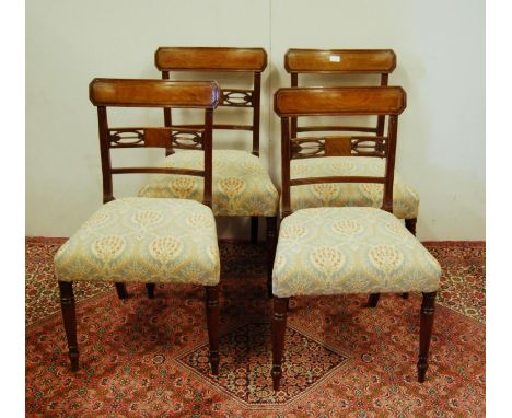 Set of four Regency-style mahogany dining chairs, each with a tablet top above a pierced bow and arrow panel, with floral dec