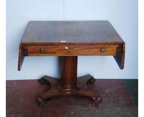 Late Regency mahogany sofa table in the manner of Gillows, the rectangular top with drop ends above a long drawer, on a facet