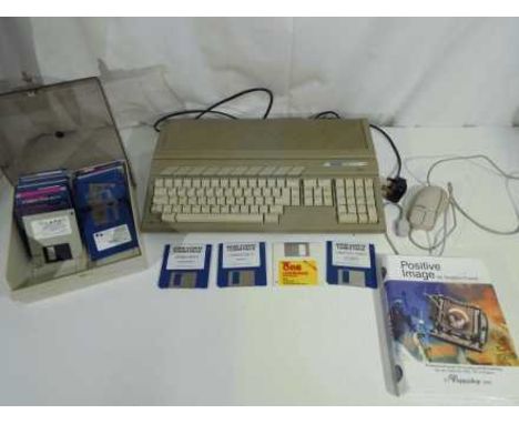 Vintage gaming - an Atari 520ST personal computer with a quantity of game and program discs to include Positive Image, Lemmin