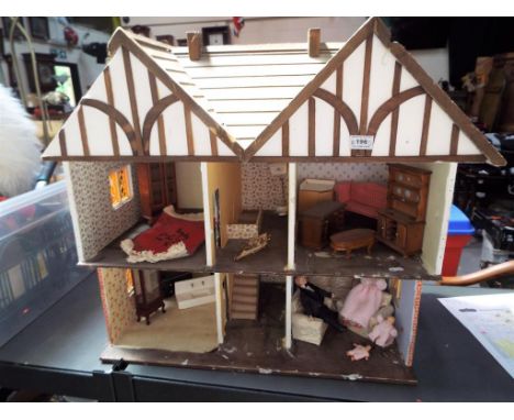 A scratch built Tudor style doll's house, approximately 60 cm x 65 cm x 37 cm with a large amount of associated furniture to 