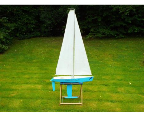 A wooden pond yacht, named Special Lady, battery powered on stand, approximately 177 cm height, 86 cm length and 22 cm depth,