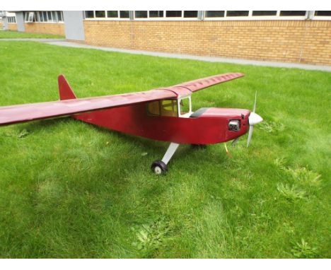 A Remote Control Model Airplane - Petrol powered. Model comes with engine. Wingspan measures approx 8Ft with a nose to tail m