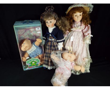 A collection of dolls to include two Cabbage Patch Kids, one boxed and two ceramic collector dolls, approximately 55 cm (h) w