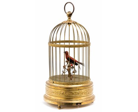 A 20th Century German gilt metal bird cage automaton, the red and black 'bird' on a perch in a circular domed cage, height 30
