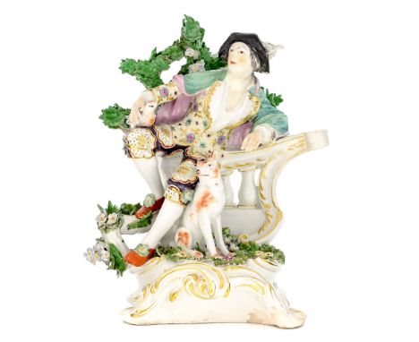 A Derby figure of a gentlemen shepherd with bird and dog, leaving on a balustrade with bocage, on rococo scroll base, gold an