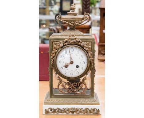 A late 19th Century French gilt metal and glass bracket clock, circa 1870, urn finial, white enamel dial, bevelled glass, bow