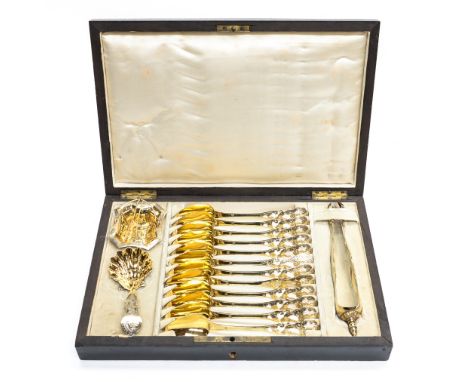 A mid 19th century French fitted wooden tea case containing twelve silver gilt teaspoons with engraved decoration, gilt sugar