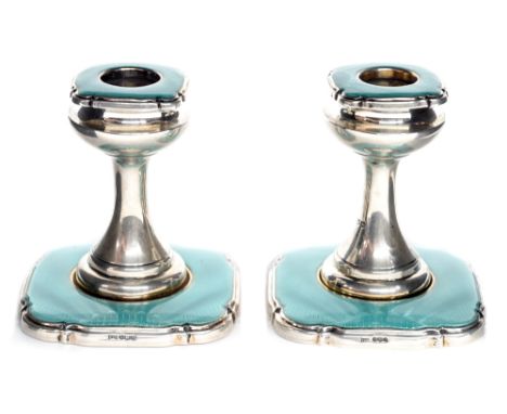 A pair of Art Deco baluster shaped desk candlesticks, the turquoise enamel nozzle and bases engine with radiating sun beam de