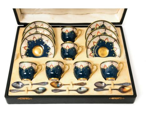 A cased early 20th Century Royal Worcester coffee set, jewelled and speckled blue decoration, gilt interiors, with silver spo