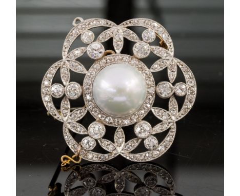 An Art Deco pearl and diamond flower head cluster pendant/brooch, the button shaped central pearl assessed as natural (untest
