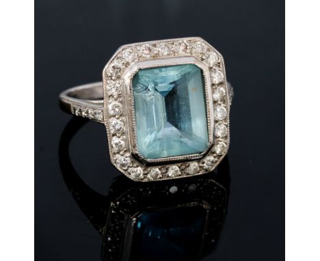 An aquamarine and diamond octagonal 18ct white gold cluster ring, the central octagonal step cut aquamarine approximately 10m