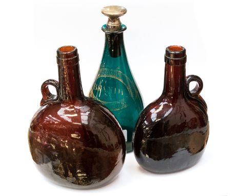 An 18th Century green glass brandy decanter, with a gilt cartouche, together with two brown glass bottles (3)