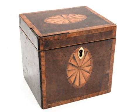 A George III mahogany single tea caddy with patera inlay, and a cold painted model of a tribal chief with parasol (2)