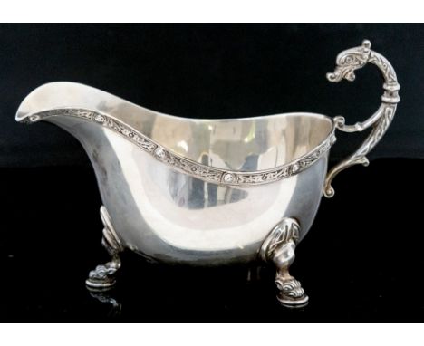 A George VI silver sauce boat, Celtic knot rim and zoomorphic handle, Birmingham 1940, 6.89ozt