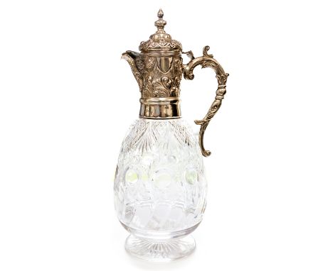 A Victorian cut crystal glass decanter with a silver collar, lid and handle, the glass being of a pear shape standing on a st