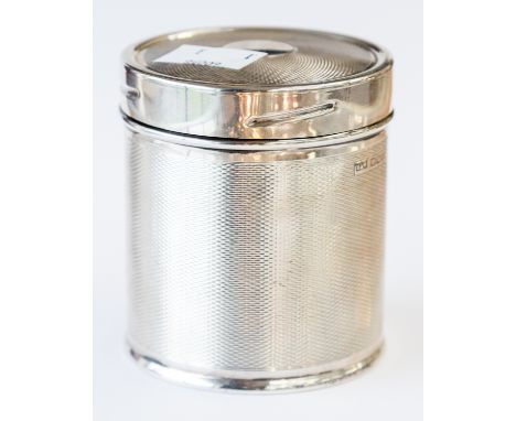 A George VI silver tea caddy or cigarette canister, engine turned cylindrical form with screw fitting lid and gilt interior, 