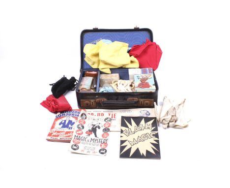A collection of vintage conjuring and magic tricks. Including instruction booklets and props in a small suitcase. L30cm x D20