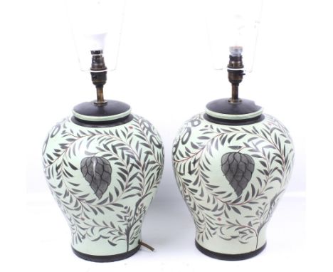 A pair of contemporary ceramic lamp bases. Painted green with fern details. H30cm (excluding fittings) Condition Report: Over