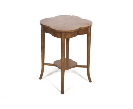 A 20th century mahogany quatrefoil shaped top side table. Turned tapering support united by a shelf. H69cm x Diameter 55cm