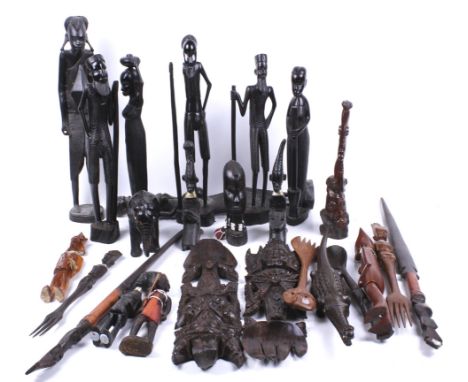 A large assortment African carved wooden sculptures. Including figures, animals, a candlestick and more, Max. H43cm