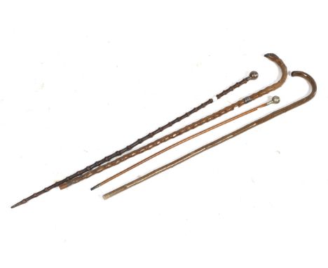 A group of three walking canes and a Somerset Light Infantry swagger stick. One with hall marked white metal collar and end. 