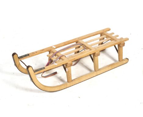 A Grindelwald oak sledge. Having metal fittings, L101cm