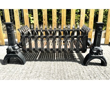 A cast iron fire grate. Painted black, the fire dogs decorated with embossed lions, H45cm x W112cm x D56cm (assembled)