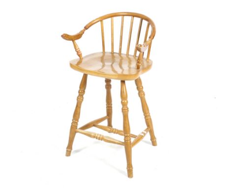 A late 20th century wooden bar stool. With bent wood arm rail, stick back and shaped seat raised on turned supports united by