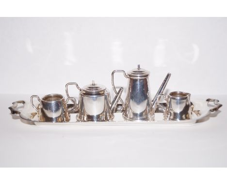 Silver four piece doll's house tea service with associated silver tray, 69 grams 