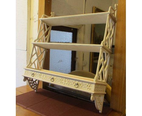 WALL SHELF, Chinese Chippendale style in a distressed cream finish enclosing shelves with three fretwork drawers below, 77cm 