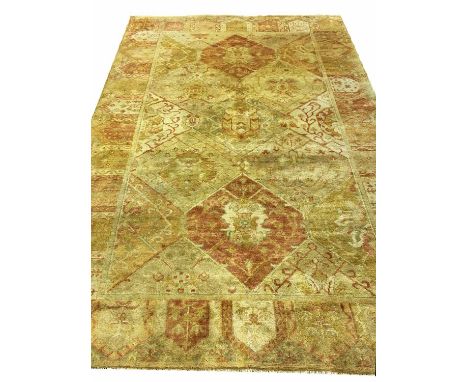 TURKISH OUSHAK CARPET, 268cm x 184cm, of repeat medallion field in shades of gold.