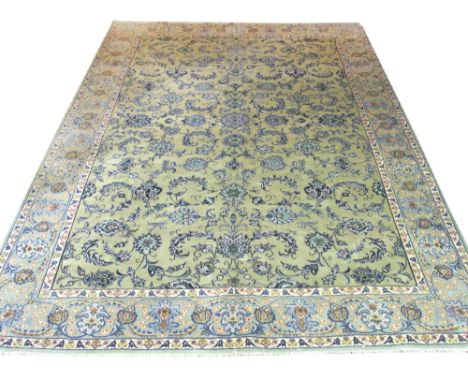 FINE KASHAN CARPET, 383cm x 294cm, all over palmette and vine design on a jade field inside ivory guard stripes and repeat pa