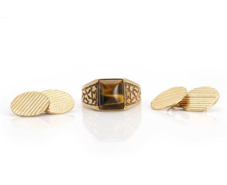 A gentleman's tiger's eye ring and a pair of cufflinks, the ring with an engraved shank, tested as approximately 9ct gold, an