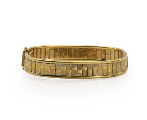 A 9ct gold bracelet, with a modernist design of polished and textured links, with a tongue and clip clasp and two safety catc