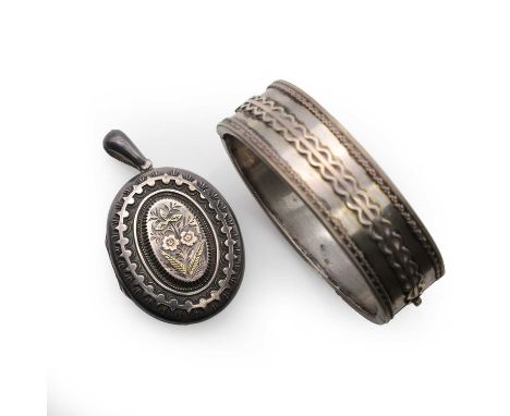 A sterling silver bangle and a sterling silver Victorian oval locket, the hinged bangle marked silver, tested as silver, and 