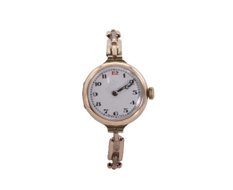 A ladies' 9ct gold mechanical bracelet watch,  26mm diameter, with a white enamel dial, red and black Arabic numerals, blued 