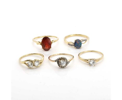 A group of five 9ct gold gem set rings, comprising a 9ct gold opal triplet ring, a 9ct gold colourless two stone crossover ri
