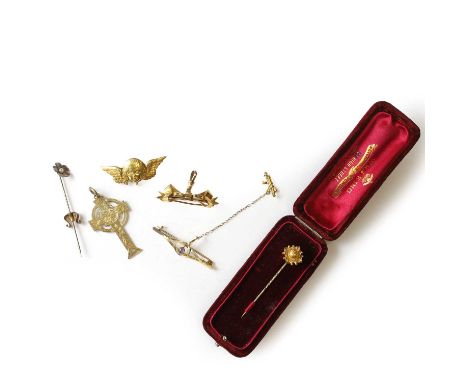 A small group of gold jewellery, an angel brooch,tested as approximately 14ct gold, a 9ct gold bow brooch,designed as a ribbo
