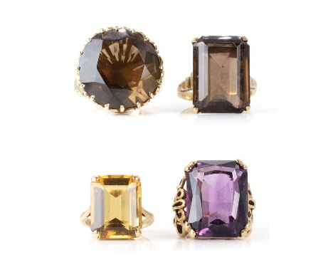 A group of four single stone gemstone rings, comprising a 9ct gold smoky quartz ring, with a round mixed cut smoky quartz, cl