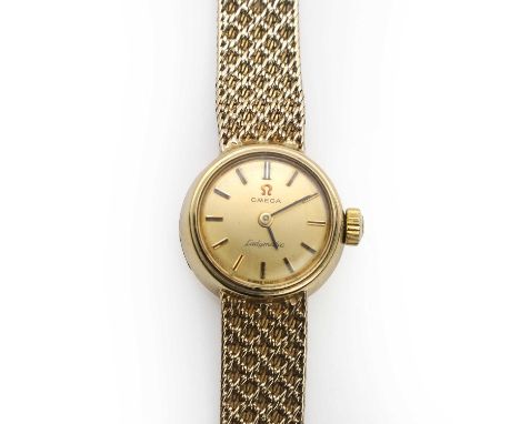 A ladies' 9ct gold Omega Ladymatic automatic bracelet watch,  with a round 16mm diameter case, a gilt dial, gilt baton hour m