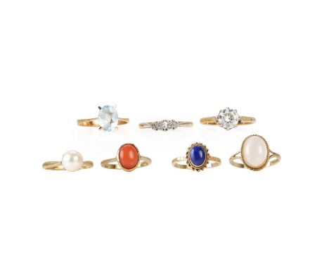 A group of gem set rings, an 18ct gold aquamarine ring, London import hallmark 1979, a diamond three stone ring, stamped 18ct