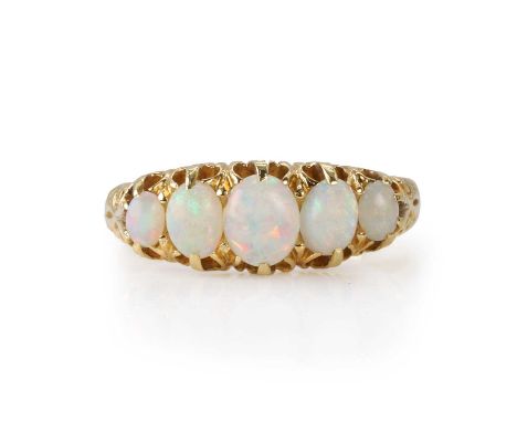 An Edwardian 18ct gold opal five stone ring,  with graduated oval cabochon opals all claw set to a scalloped gallery, to soli