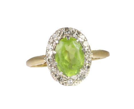 An 18ct gold peridot cluster ring,  with an oval cut peridot, approximately 8 x 6mm, claw set to a white gold gallery set to 