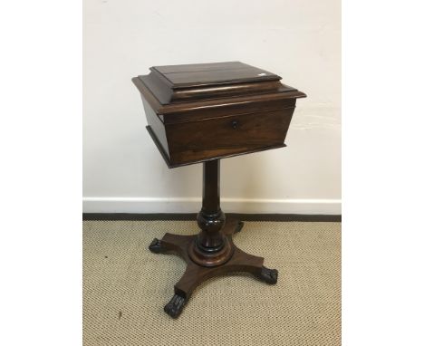 An early Victorian rosewood teapoy of caddy form, the top opening to reveal a four canister interior with two central mixing 