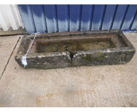 A natural stone trough of rectangular form with pouring spout to long edge, 116 cm long x 38 cm deep x 21 cm high