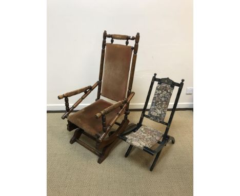 A Victorian turned and ringed walnut framed rocking armchair, a late Victorian child's ebonised and upholstered folding chair