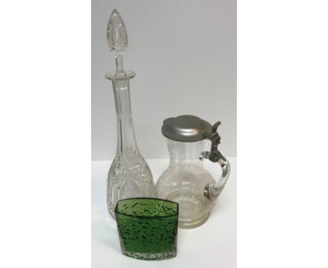 A collection of glassware to include four cut glass decanters, a pair of baluster shaped jugs with engraved decoration and pe