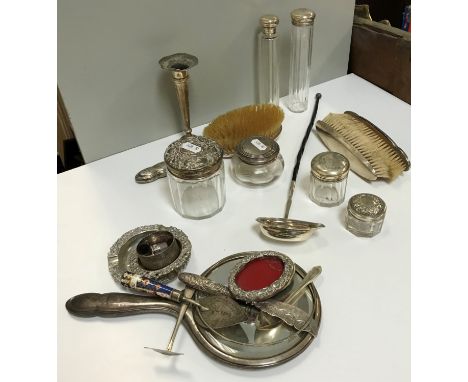 A collection of silver wares to include a collection of various cut glass silver topped dressing table bottles, three silver 