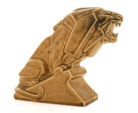 * Metcalfe (Percy, 1895-1970). An Ashstead Potters Ltd 'Lion on Industry' c.1925, the pottery lion with a sand coloured glaze