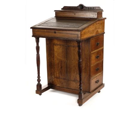 * Davenport. A Victorian walnut davenport, with raised cupboard enclosing stationary compartments the hinged fall with tooled